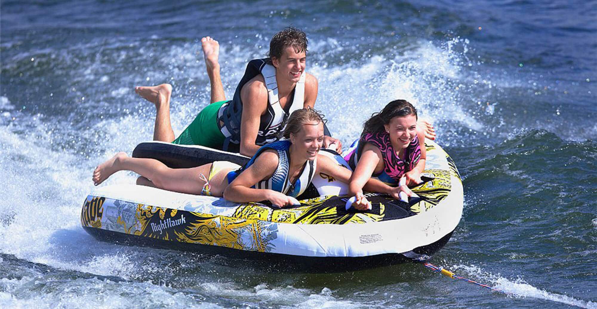 A group of teenagers enjoying watersport tubing on Lake Geneva
